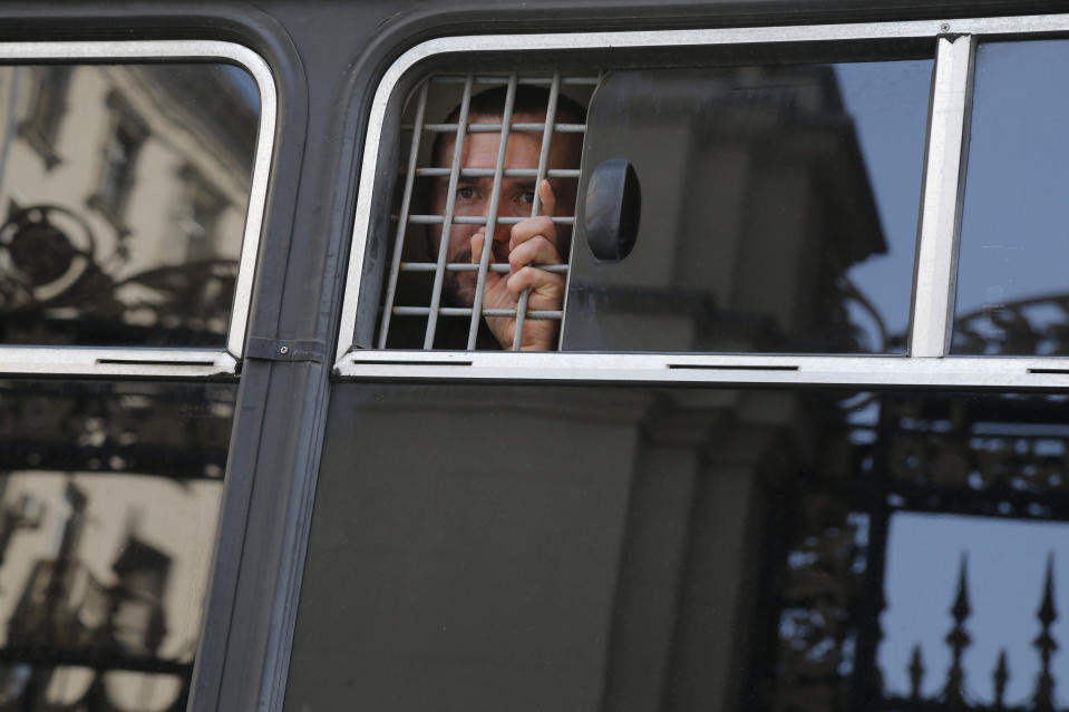 A detained protester looks out of a police bus window prior to an unsanctioned rally in the center of Moscow, Russia, Saturday, July 27, 2019. Police have established a heavy presence at the Moscow mayor's office ahead of an expected protest rally and several opposition figures have been detained. (AP Photo/Alexander Zemlianichenko)