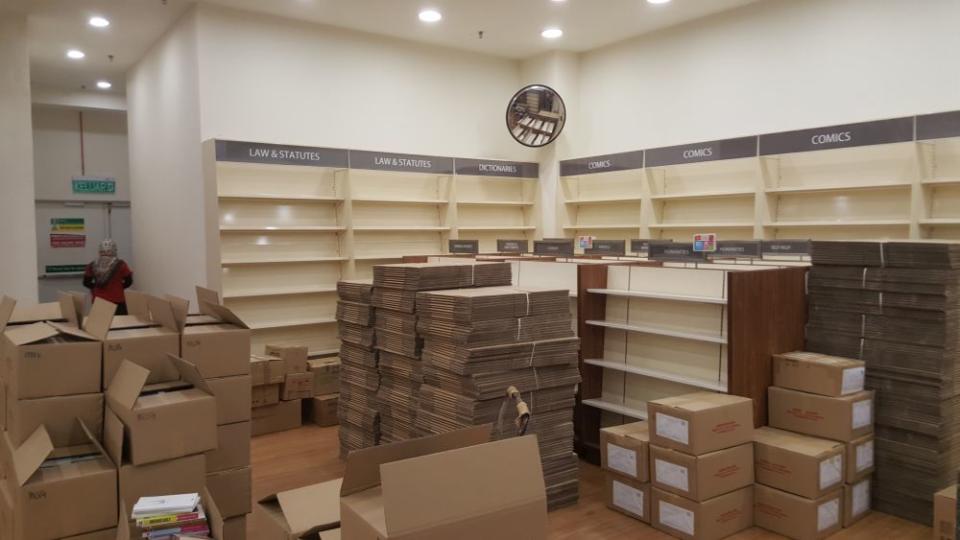 Empty shelves and stacks of boxes loaded with books and stationary are pictured as the MPH MyTown bookstore prepares to close this Saturday, June 6, 2020. — Picture by R. Loheswar