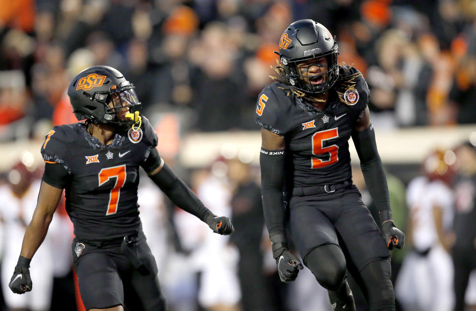 Nov 12, 2022; Stillwater, Oklahoma, USA; Oklahoma State Cowboys safety Kendal Daniels (5) and cornerback Jabbar Muhammad (7) celebrate after a defensive stop against the Iowa State Cyclones in the fourth quarter at Boone Pickens Stadium. OSU won 20-14. Mandatory Credit: Sarah Phipps-USA TODAY Sports