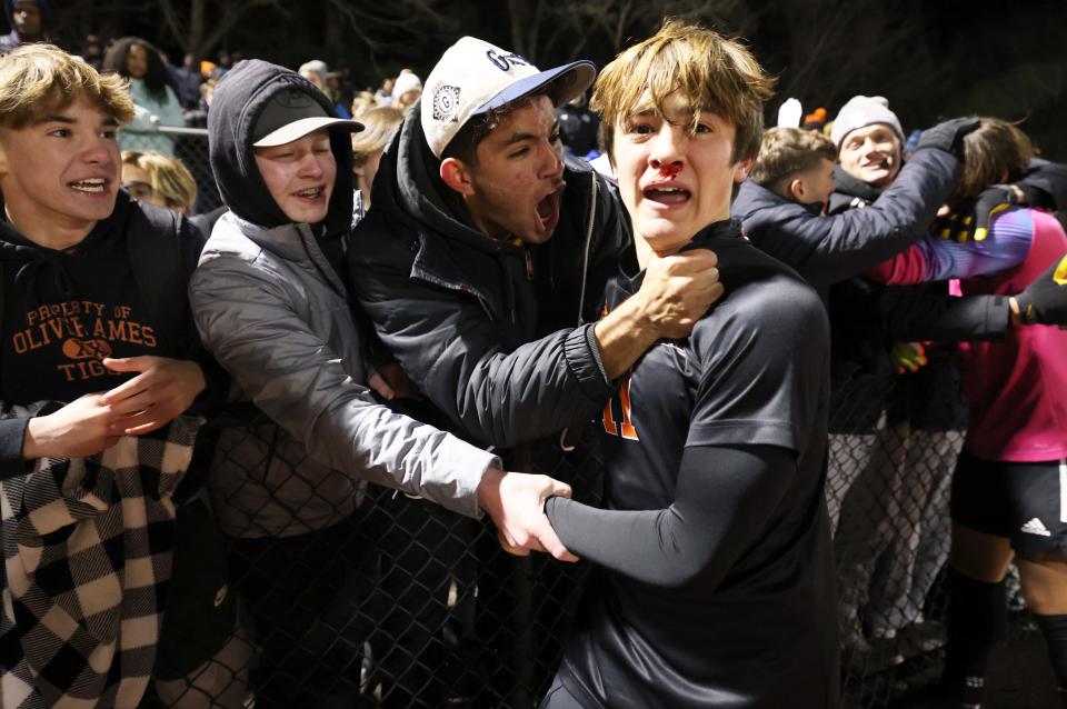 Oliver Ames player Casey Milliken celebrates after winning  the Division 2 state championship at Walpole High School with a 3-2 win over Hopkinton on Saturday, Nov. 19, 2022.   