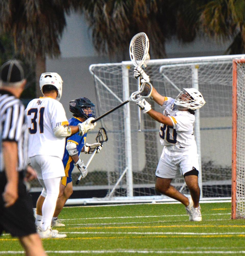 Boca Raton goaltender Miller Dickenson makes a save during the Bobcats' regional quarterfinal win over Martin County on April 25, 2024.