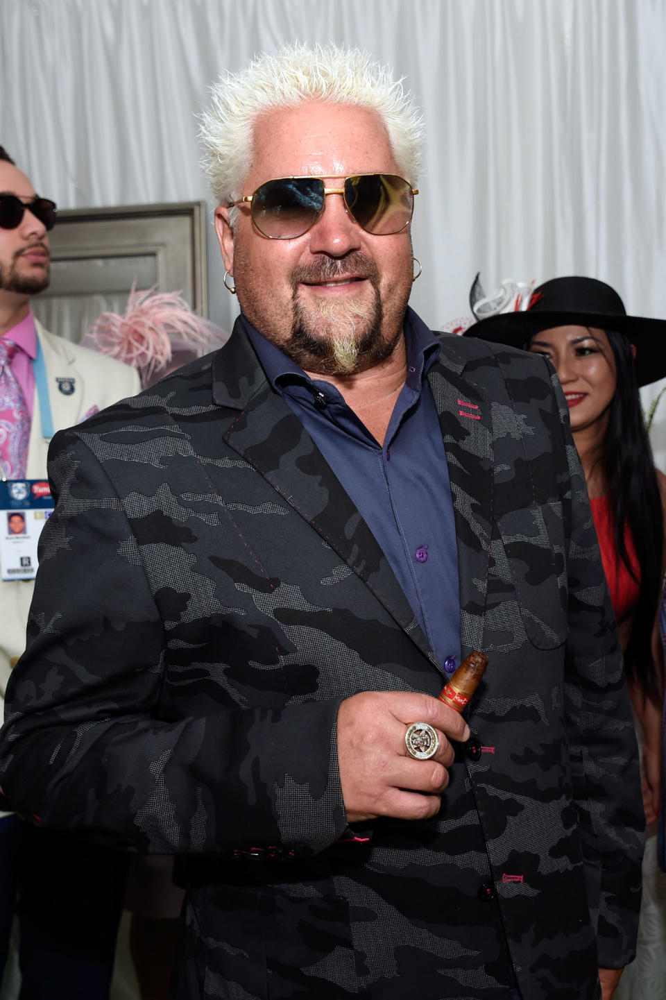 Fieri holds a cigar at an event