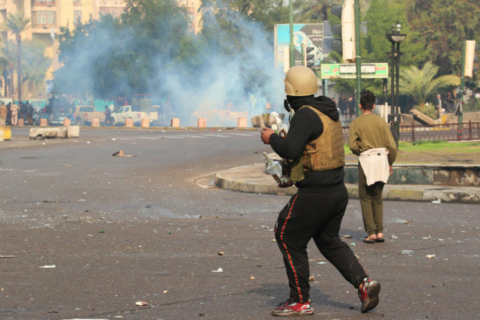 Smoke rise from tear gas fired by security forces during clashes with anti-government protesters in Baghdad, Iraq, Saturday, Jan. 25, 2020. Security forces set fire to anti-government protest tents in the country's south early Saturday and re-opened key public squares in Baghdad that had been occupied by demonstrators for months. (AP Photo/Hadi Mizban)