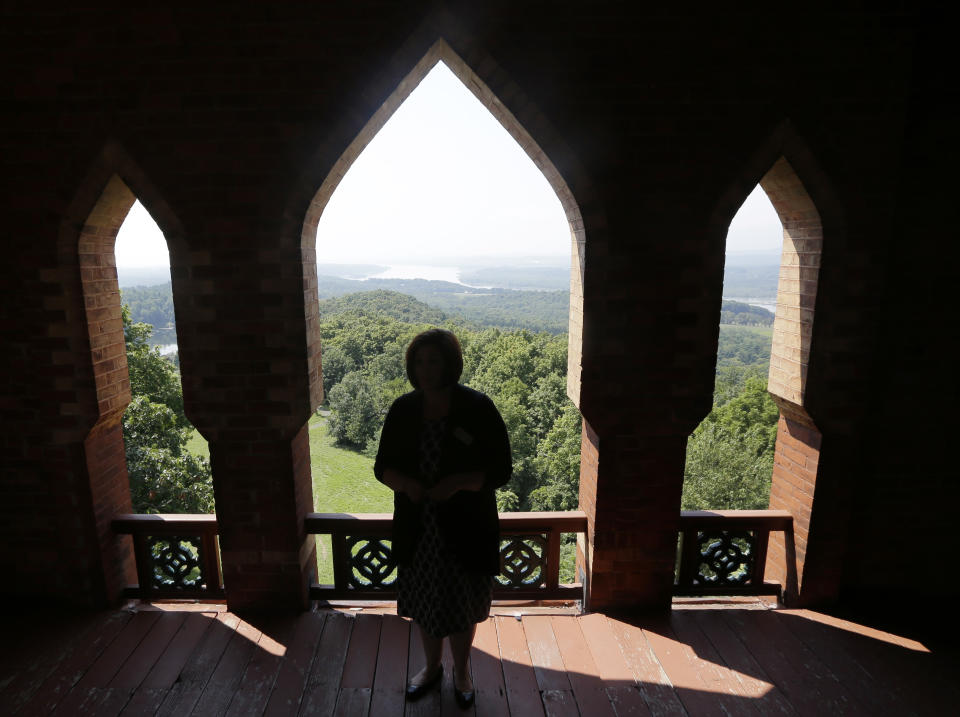 In this Wednesday, Aug. 21, 2013, photo, Valrie Balint, associate curator at Olana State Historic Site, takes in the views of the Hudson Valley from the bell tower of of the Olana State Historic Site in Greenport, N.Y. Keeping the grounds unmarred by the trappings of modern technology is the focus of a legal fight over plans for a 190-foot emergency communications tower 2 miles from Church’s old estate, Olana. (AP Photo/Mike Groll)