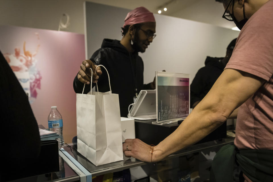 A person purchases cannabis products at Housing Works Cannabis Co., New York's first legal cannabis dispensary at 750 Broadway in Noho on Thursday, Dec. 29, 2022, in New York. (AP Photo/Stefan Jeremiah)