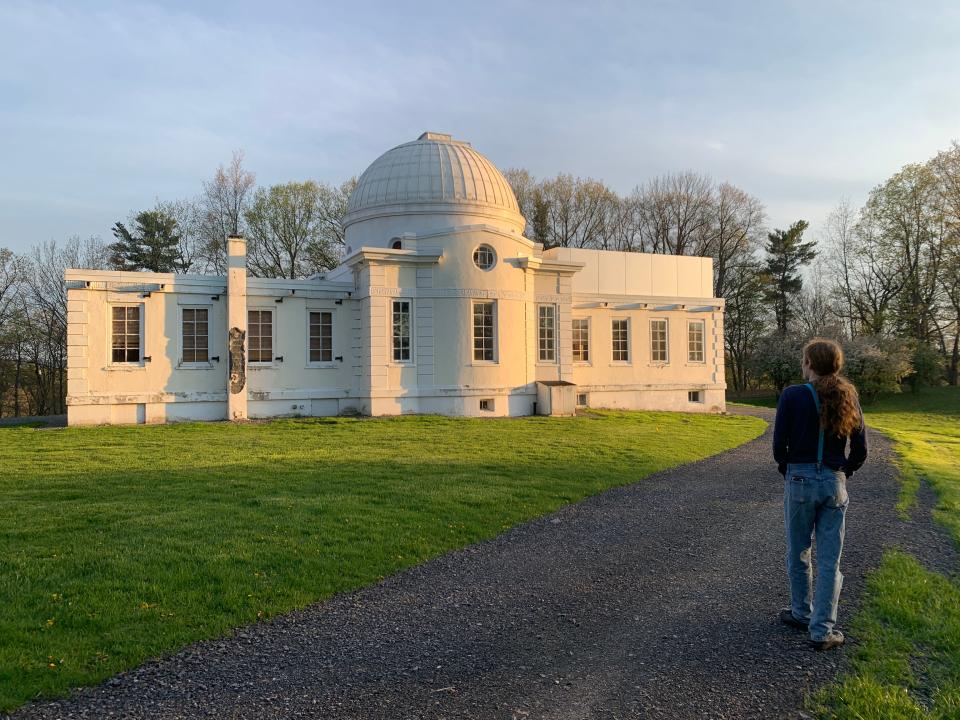 A student walks to Fuertes Observatory on Cornell's Ithaca campus.