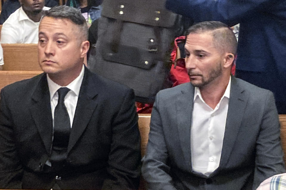 Jacob Runyan, left, and Chase Cominsky, sit in court as they are arraigned, Wednesday, Oct. 26, 2022, in Cleveland. The two pleaded not guilty to cheating and other charges in a lucrative fishing tournament on Lake Erie in the end of September where they were accused of stuffing five walleye with lead weights and fish filets. (AP Photo/Mark Gillispie)