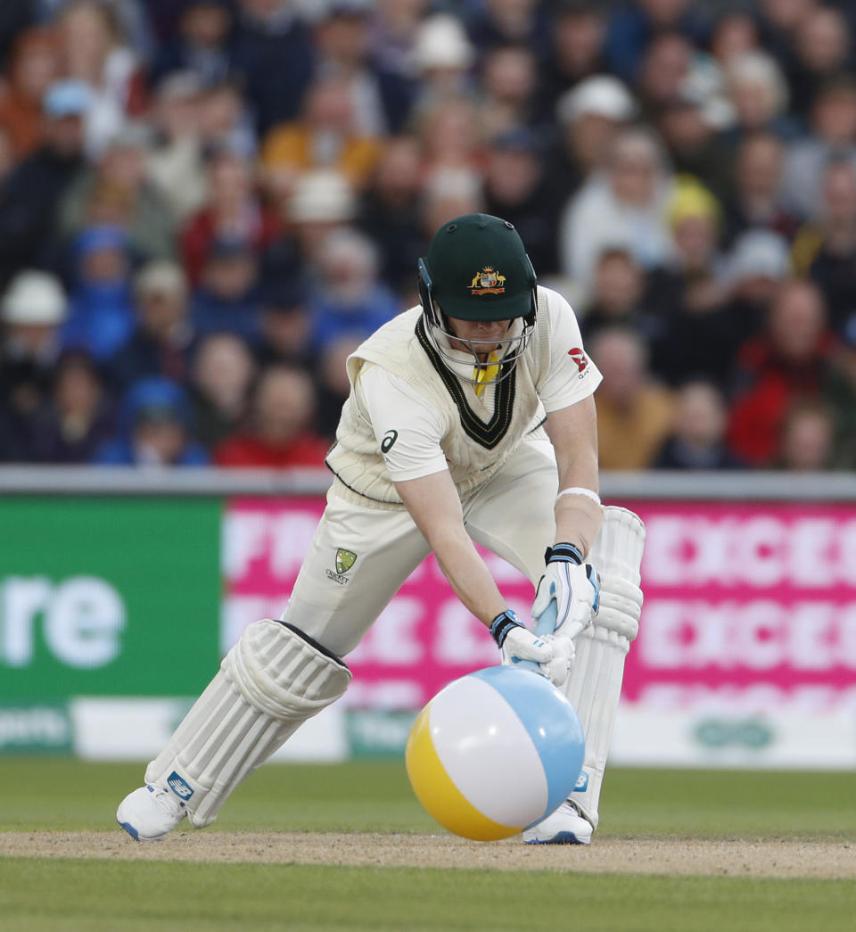 Australia's Steve Smith clears a rubber ball that entered the field during day one of the fourth Ashes Test cricket match between England and Australia at Old Trafford in Manchester, England, Wednesday, Sept. 4, 2019. (AP Photo/Rui Vieira)