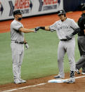 New York Yankees third base coach Phil Nevin, left, congratulates Gio Urshela, right, after two runs scored on an error by Tampa Bay Rays center fielder Manuel Margot during the fifth inning of a baseball game Sunday, Aug. 9, 2020, in St. Petersburg, Fla. (AP Photo/Steve Nesius)