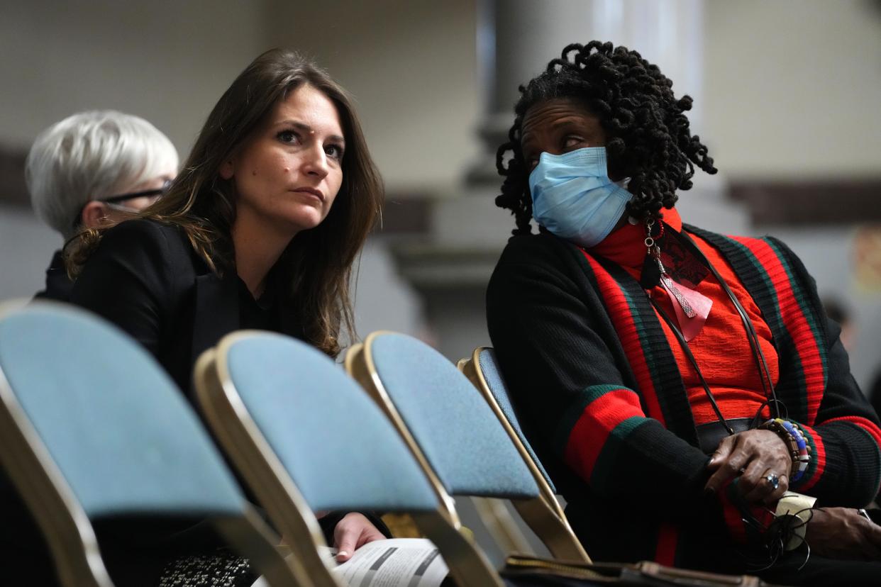 Samantha Silverstein, training director at the Hamilton County Public Defender office, left, speaks with Iris Roley, right, during a Cincinnati Citizen Complaint Authority board meeting, Monday, Feb. 6, 2023, in council chambers at City Hall in downtown Cincinnati.