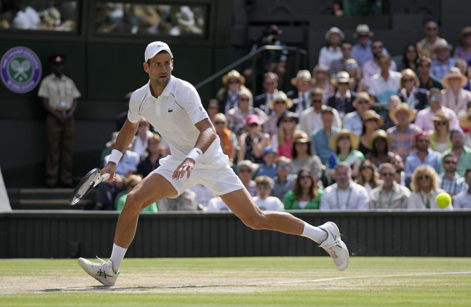 Serbia's Novak Djokovic returns to Australia's Nick Kyrgios in the final of the men's singles on day fourteen of the Wimbledon tennis championships in London, Sunday, July 10, 2022. (AP Photo/Alastair Grant)