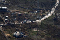 <p>An United Nations convoy drive next to destroyed houses after Hurricane Matthew hit Jeremie, Haiti, October 10, 2016. (Carlos Garcia Rawlins/Reuters)</p>