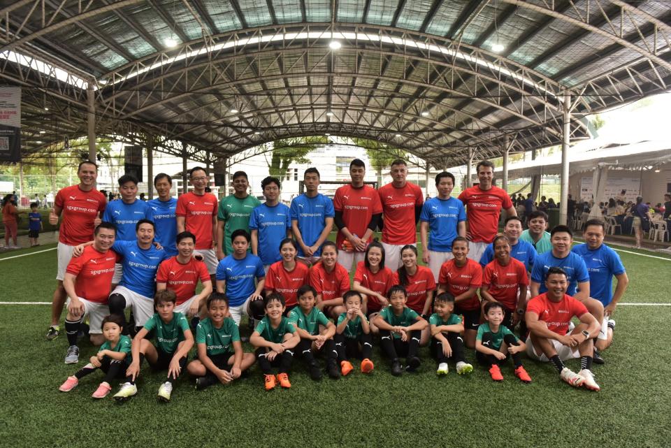 The SGX Group teams together with Singapore football greats at the SGX Cares Bull Charge Charity Futsal at Kick Off! in Kovan. (PHOTO: SGX)