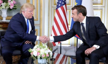 FILE PHOTO: U.S. President Donald Trump and French President Emmanuel Macron meet at the Prefecture of Caen, Normandy