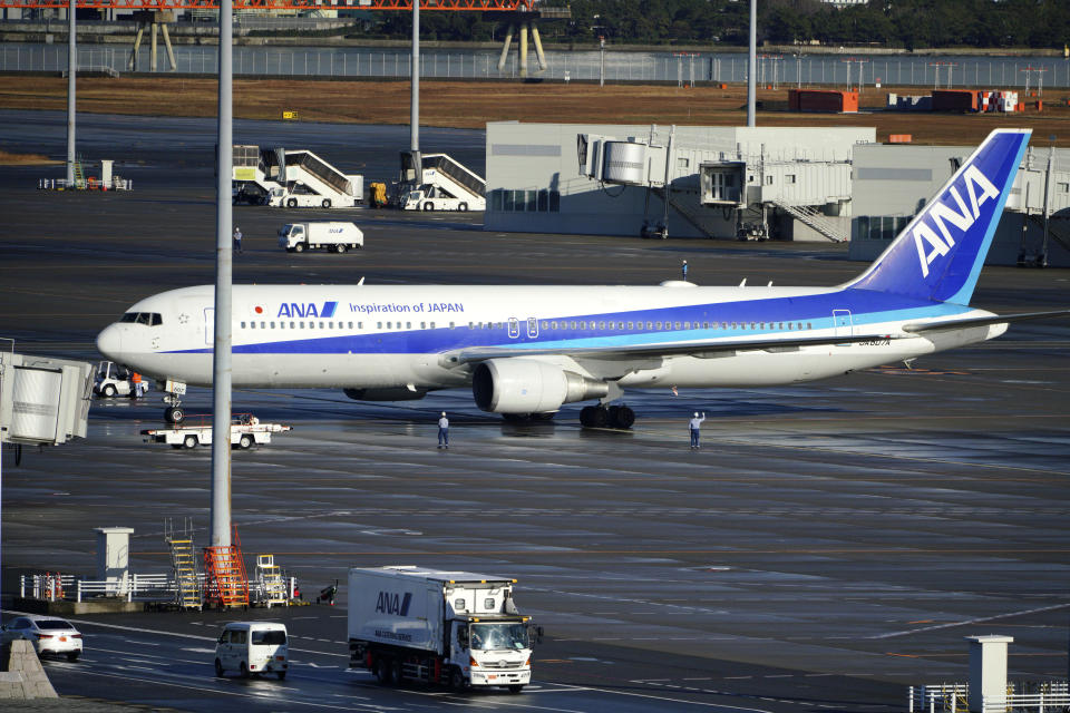 A Japanese chartered plane carrying evacuees from Wuhan, China, landed at Haneda international airport in Tokyo Wednesday, Jan. 29, 2020. Countries on Wednesday began evacuating their citizens from the Chinese city hardest-hit by an outbreak of a new virus. (AP Photo/Eugene Hoshiko)