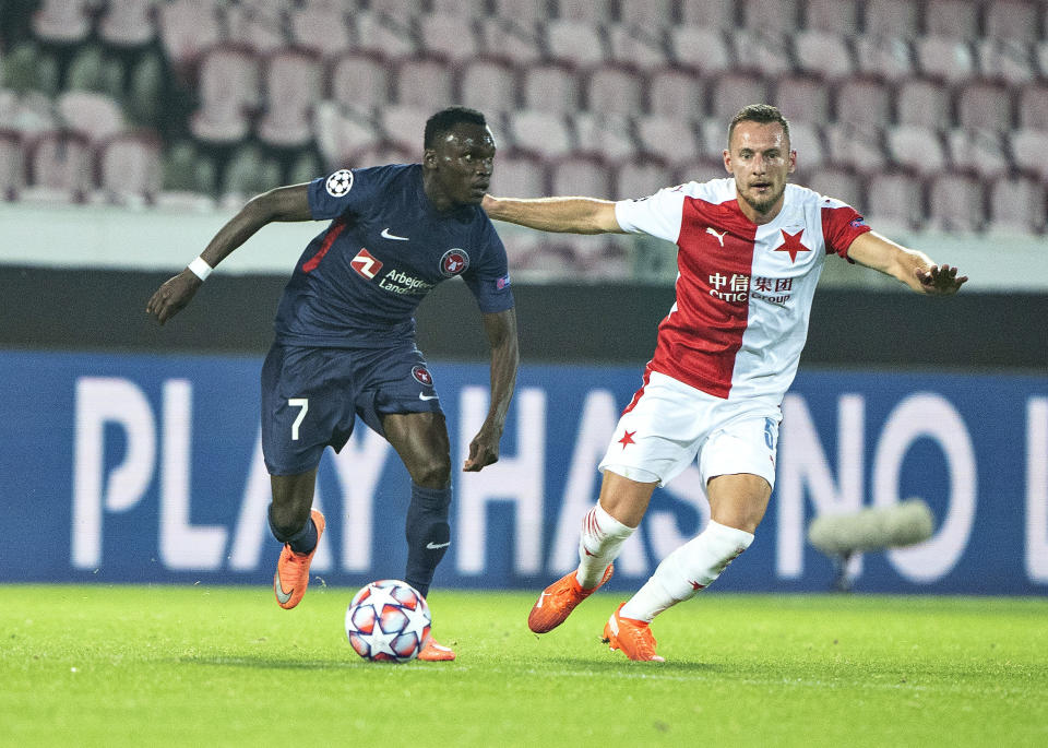 FILE - In this Wednesday, Sept. 30 2020 file photo, FC Midtjylland's Pione Sisto, left, vies for the ball with Slavia Prague's David Zima, during the Champions League play off qualifier soccer match between FC Midtjylland and Slavia Prague at MCH Arena in Herning, Denmark. FC Midtjylland has been one of the poster teams for analytics in European soccer. Now the Danish club is about to find out how its data-driven and statistical approach fares in the Champions League after qualifying for the competition’s group stage for the first time. (Henning Bagger/Ritzau Scanpix via AP, File)