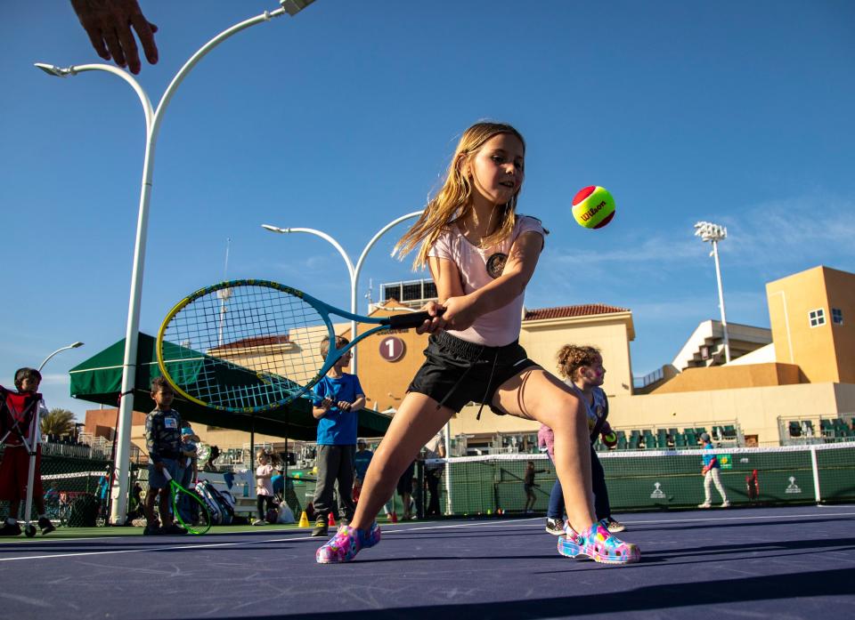 Penelope Davis, 8, of Palm Desert practices tennis during the BNP Paribas Open Family Day at the Indian Wells Tennis Garden in Indian Wells, Calif., Saturday, March 4, 2023. 