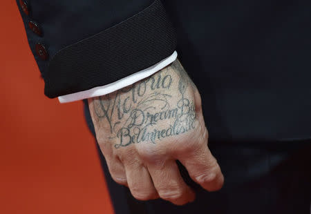 A tattoo reading 'Victoria Dream Big Be Unrealistic' on the hand of David Beckham, as he arrives at the British Academy of Film and Arts (BAFTA) awards ceremony at the Royal Opera House in London, February 8, 2015. REUTERS/Toby Melville