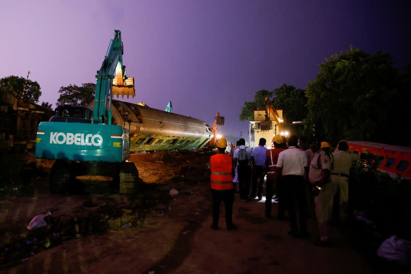 FILE PHOTO: Families, rescuers search for victims of India's worst train crash in decades