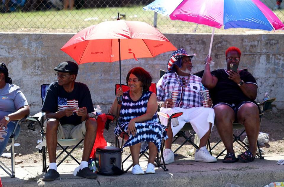 Spectators watch as the annual Fourth of July parade rolls through the Como neighborhood on Tuesday, July 4, 2023.