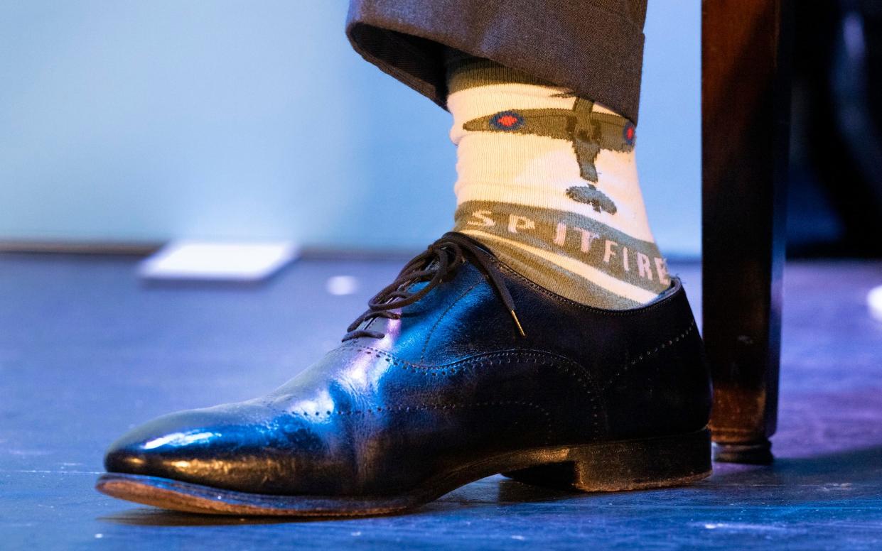 Reform Party Leader Nigel Farage wears Spitfire decorated socks on stage at the Princes Theatre in Clacton on Sea in Essex