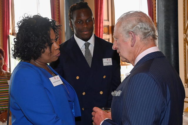 LONDON, ENGLAND - JUNE 09: Prince Charles, Prince of Wales, meets singer and TV presenter Brenda Edwards and rugby player Oghenemaro Miles 
