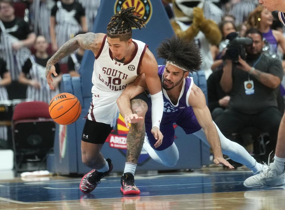 GCU Lopes forward Gabe McGlothan (30) fights for a loose ball with South Carolina Gamecocks guard Myles Stute (10) at Desert Diamond Arena in Glendale on Nov. 19, 2023.