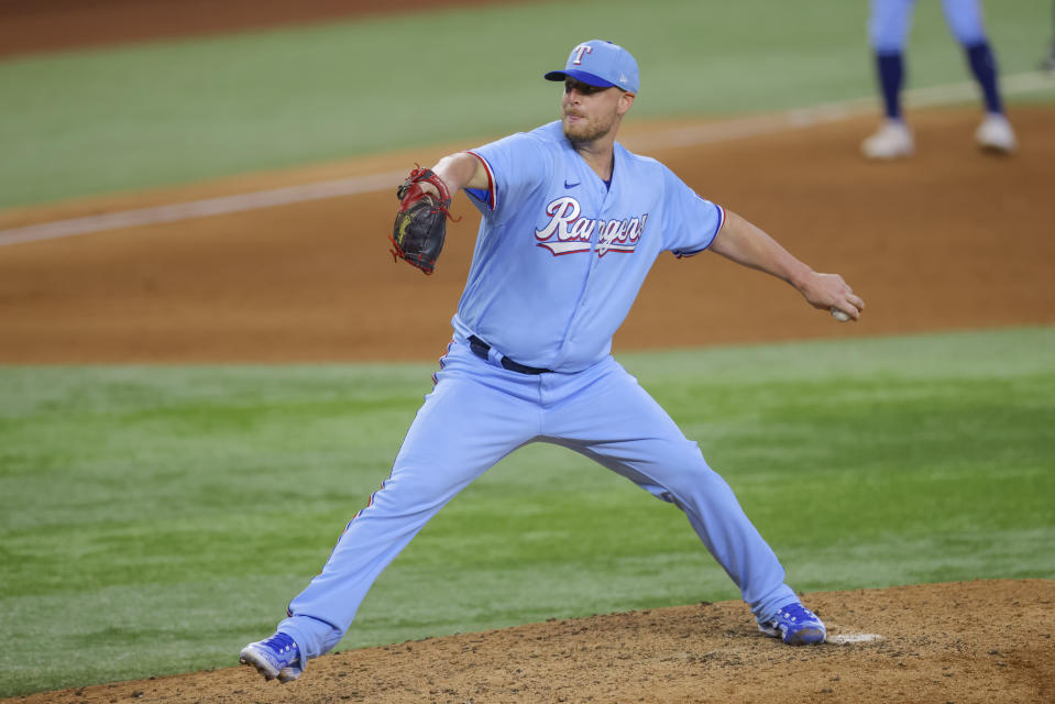 Texas Rangers' relief pitcher Will Smith delivers in the ninth inning of a baseball game against the Cleveland Guardians, Sunday, July 16, 2023, in Arlington, Texas. (AP Photo/Gareth Patterson)