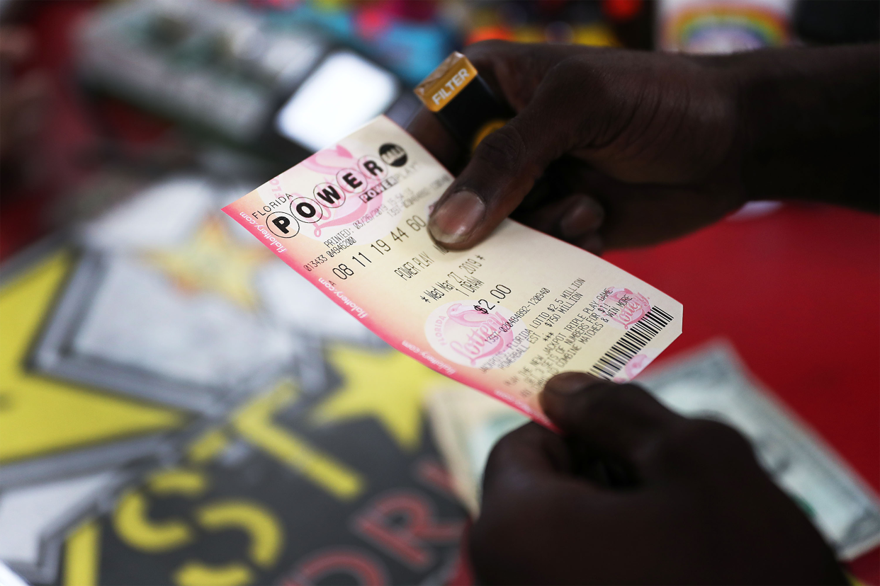 man holding powerball lottery ticket