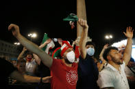 Italian fans celebrate as they watch the Euro 2020, soccer championship group A match between Italy and Turkey, on a mega screen set in downtown Rome, Friday, June 11, 2021. (Cecilia Fabiano/LaPresse via AP)