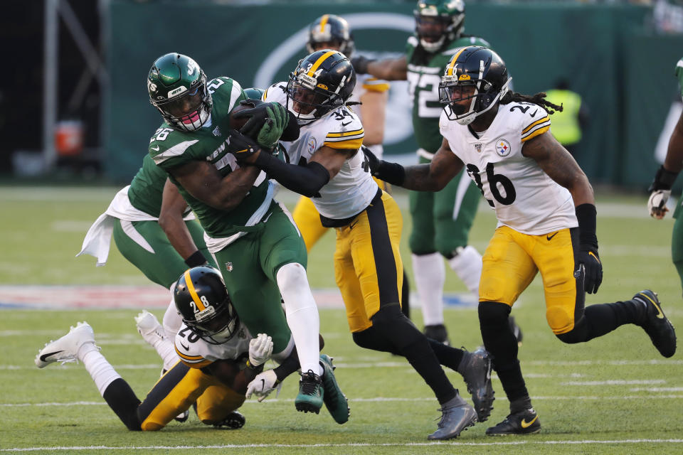 New York Jets running back Le'Veon Bell (26) is stopped by Pittsburgh Steelers strong safety Terrell Edmunds (34) and Pittsburgh Steelers cornerback Mike Hilton (28) in the second half of an NFL football game, Sunday, Dec. 22, 2019, in East Rutherford, N.J. (AP Photo/Seth Wenig)