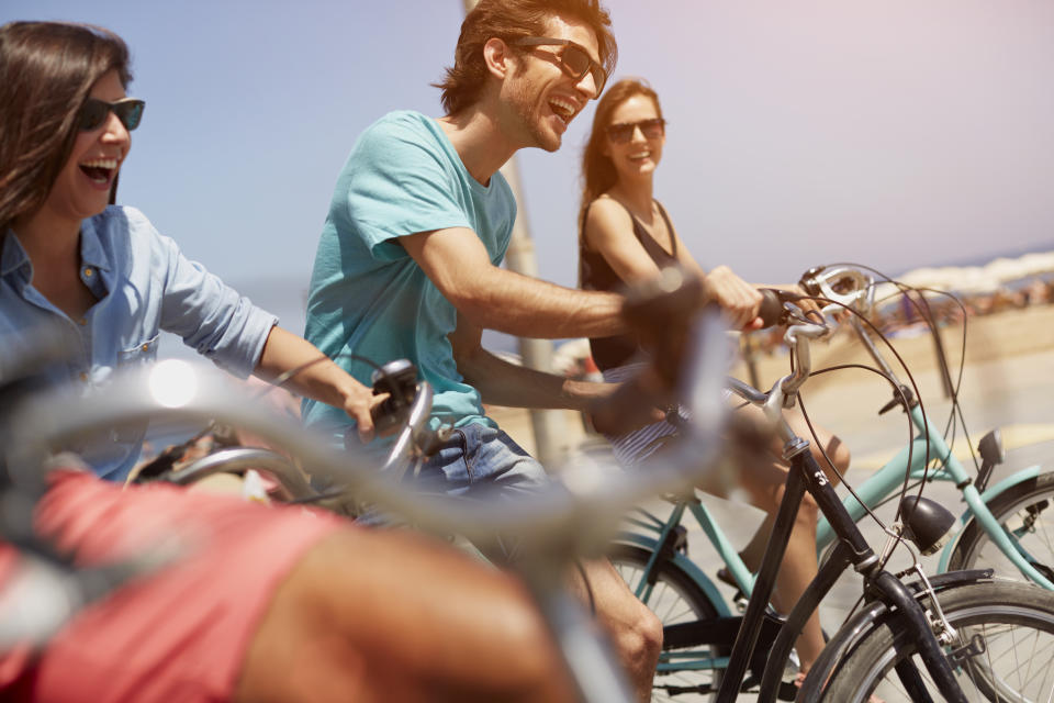 Happy young friends riding bicycles together