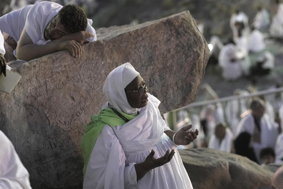 A Muslim pilgrim prays on the rocky hill known as the Mountain of Mercy, on the Plain of Arafat, during the annual Hajj pilgrimage, near the holy city of Mecca, Saudi Arabia, Tuesday, June 27, 2023. Around two million pilgrims are converging on Saudi Arabia's holy city of Mecca for the largest Hajj since the coronavirus pandemic severely curtailed access to one of Islam's five pillars. (AP Photo/Amr Nabil)