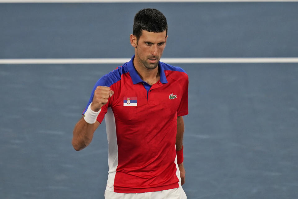 Novak Djokovic, of Serbia, reacts after winning the first set against Kei Nishikori, of Japan, during the quarterfinals of the tennis competition at the 2020 Summer Olympics, Thursday, July 29, 2021, in Tokyo, Japan. (AP Photo/Seth Wenig)