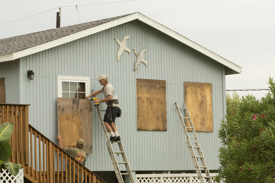 Residents board up the windows of a home ahead of in Jamaica Beach.&nbsp;