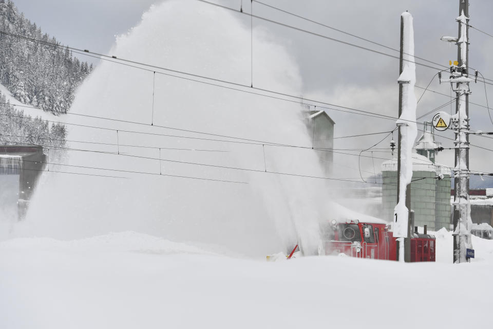 A railway cleans snow from the rails on Saturday, Jan. 12, 2019 in Hochfilzen, Austrian province of Tyrol.(AP Photo/Kerstin Joensson)