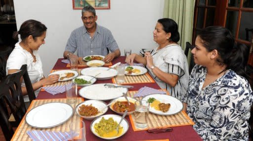 Former army chief Sarath Fonseka (C) having a dinner with his wife Anoma (C2) and daughters Aparna (R) and Apsara (L) following Fonseka's release from prison