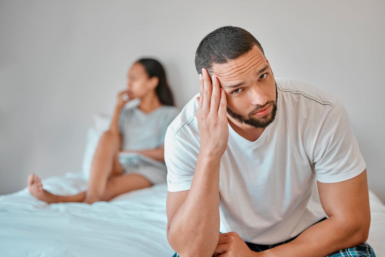 Couple, divorce and stress in home bedroom, fighting or argument. Portrait, anxiety and unhappy man and woman, sad and depressed after infidelity, toxic relationship or failed marriage in house.