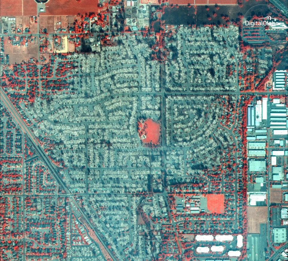 <p>This Wednesday, Oct. 11, 2017, satellite image using a Very Near Infrared (VNIR) provided by DigitalGlobe shows damage from the wildfire in Santa Rosa, Calif. VNIR imagery causes healthy vegetation to appear red and the burn scar from the wildfire to appear dark brown. Wildfires whipped by powerful winds swept through northern California, sending residents on a headlong race to safety through smoke and flames as homes burned. (Photo: Digital Globe via AP) </p>