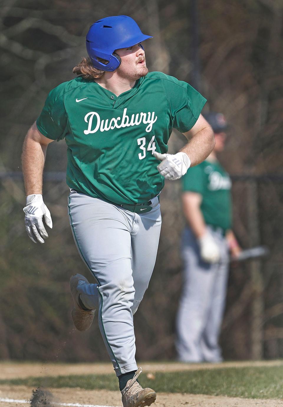 Dragons third baseman Nick Ayres who is hot slugging early in the season watches a deep shot to center field for a two RBI double.Duxbury hosted Silver Lake High in baseball  on Friday April 14, 2023 