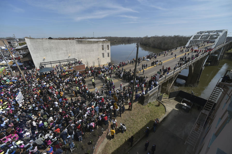 FILE - In this Sunday, March 8, 2015, file photo, crowds gather before a symbolic walk across the Edmund Pettus Bridge, in Selma, Ala. Some residents in the landmark civil rights city of Selma, Alabama, are among the critics of a bid to rename the historic bridge where voting rights marchers were beaten in 1965. (AP Photo/Mike Stewart, File)