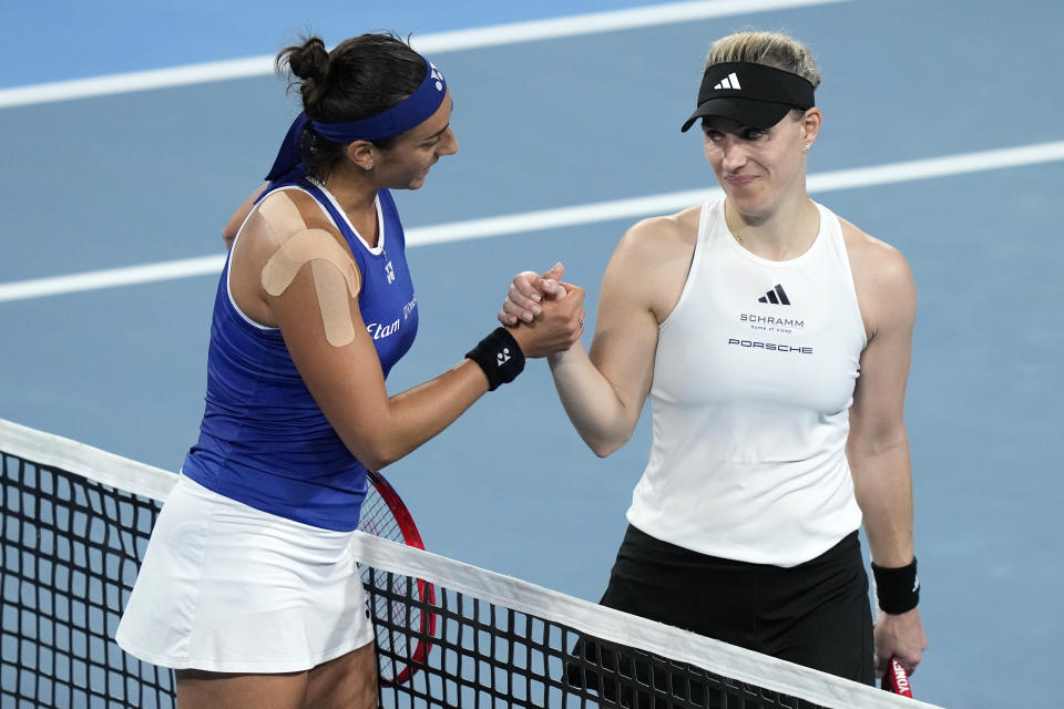 France's Caroline Garcia, left, and Germany's Agelique Kerber meet at the net after Garcia won their match during the United Cup tennis tournament in Sydney, Monday, Jan. 1, 2024. (AP Photo/Rick Rycroft)