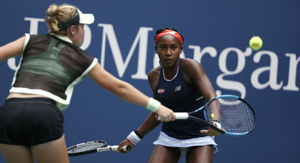 Coco Gauff, right, watches as her partner Catherine McNally returns during their women's doubles second round match against Nicole Melichar and Kveta Peschjka at the US Open tennis championships Sunday, Sept. 1, 2019, in New York. (AP Photo/Kevin Hagen)