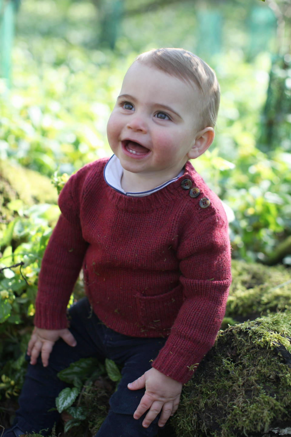 Louis wore this buttoned burgundy sweater for some of the photos. (Photo: Duchess of Cambridge/Reuters)