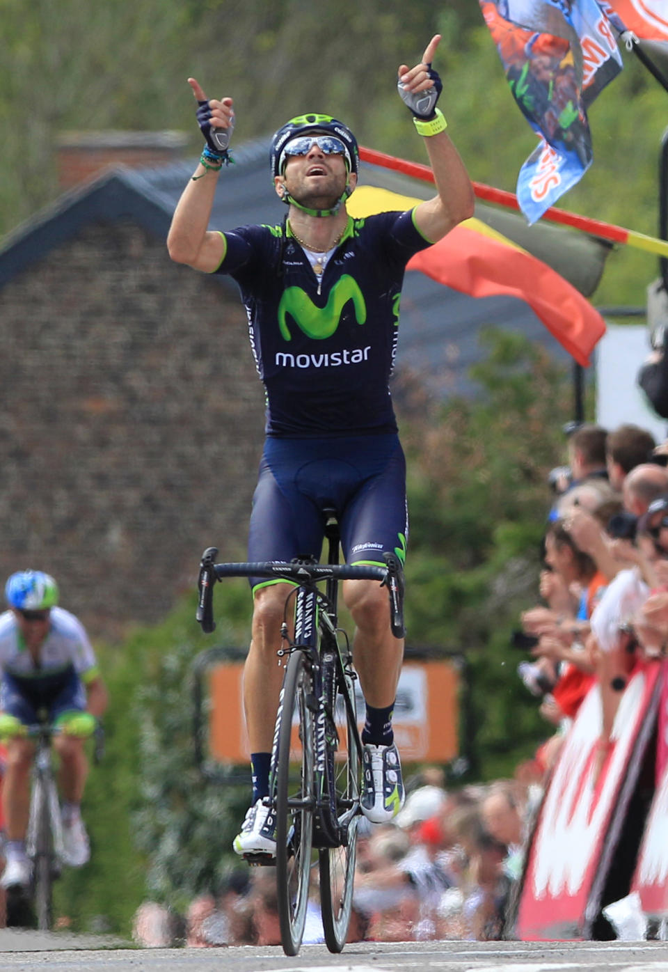 Spain's Alejandro Valverde of the Movistar team celebrates as he wins the Belgian cycling classic Walloon Arrow/Fleche Wallonne, in Huy, Belgium, Wednesday, April 23, 2014. Ireland's Daniel Martin of the Garmin team came second, Poland's Michal Kwiatkowski of the Omega Pharma team was third. (AP Photo/Yves Logghe)