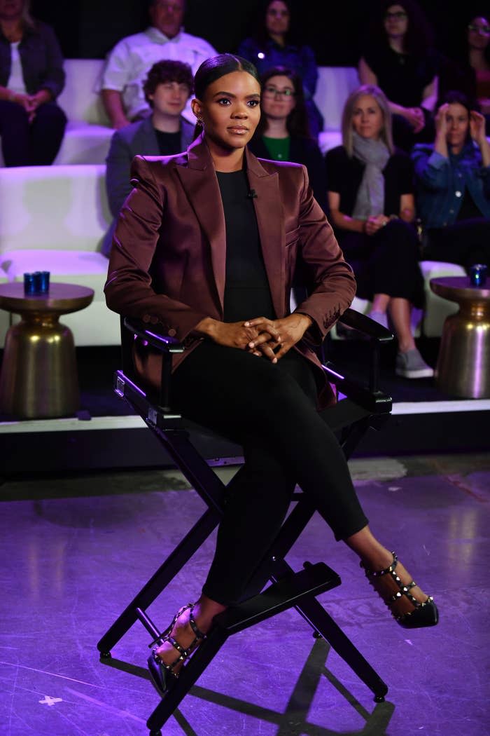 Candace sitting in a director's chair on a set with a studio audience