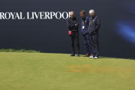 Officials look at orange material thrown down by protesters the 17th hole during the second day of the British Open Golf Championships at the Royal Liverpool Golf Club in Hoylake, England, Friday, July 21, 2023. (AP Photo/Peter Morrison)
