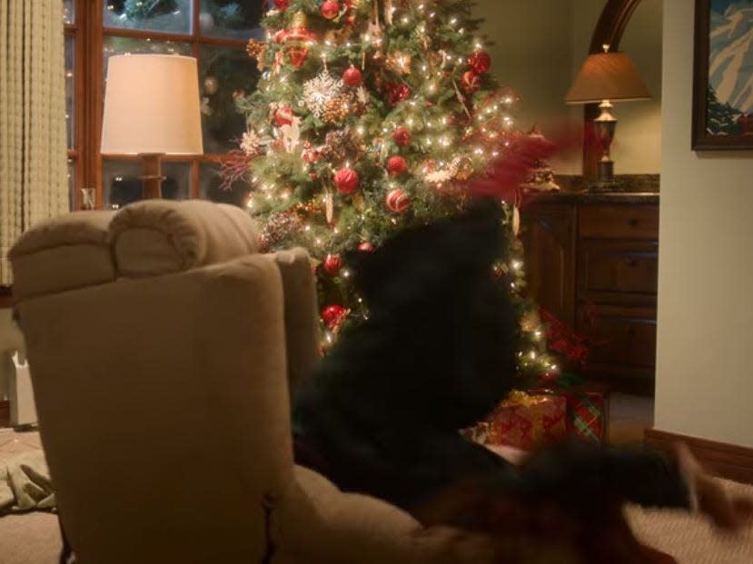 sierra falling over a recliner chair in a lodge room in falling for christmas