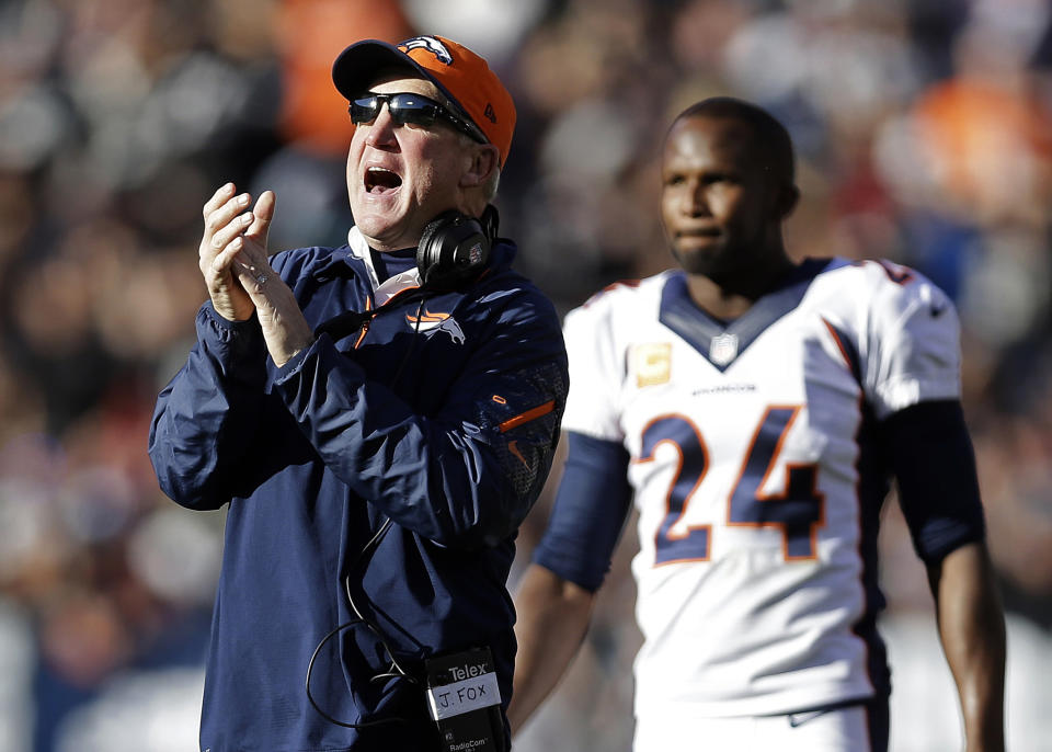 FILE - In this Dec. 29, 2013, file photo, Denver Broncos head coach John Fox celebrates in front of defensive back Champ Bailey after quarterback Peyton Manning threw a 63-yard touchdown pass to wide receiver Demaryius Thomas during the second quarter of an NFL football game against the Oakland Raiders in Oakland, Calif. Since returning from his heart operation last month, Fox seems like a new man. More pep in his step, more color in his face, more boom in his voice. Even more gumption in his calls. (AP Photo/Marcio Jose Sanchez, File)