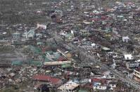 An aerial view shows damaged houses brought by Typhoon Haiyan in the province of Leyte, central Philippines November 10, 2013. REUTERS/Ryan Lim/Malacanang Photo Bureau/Handout via Reuters